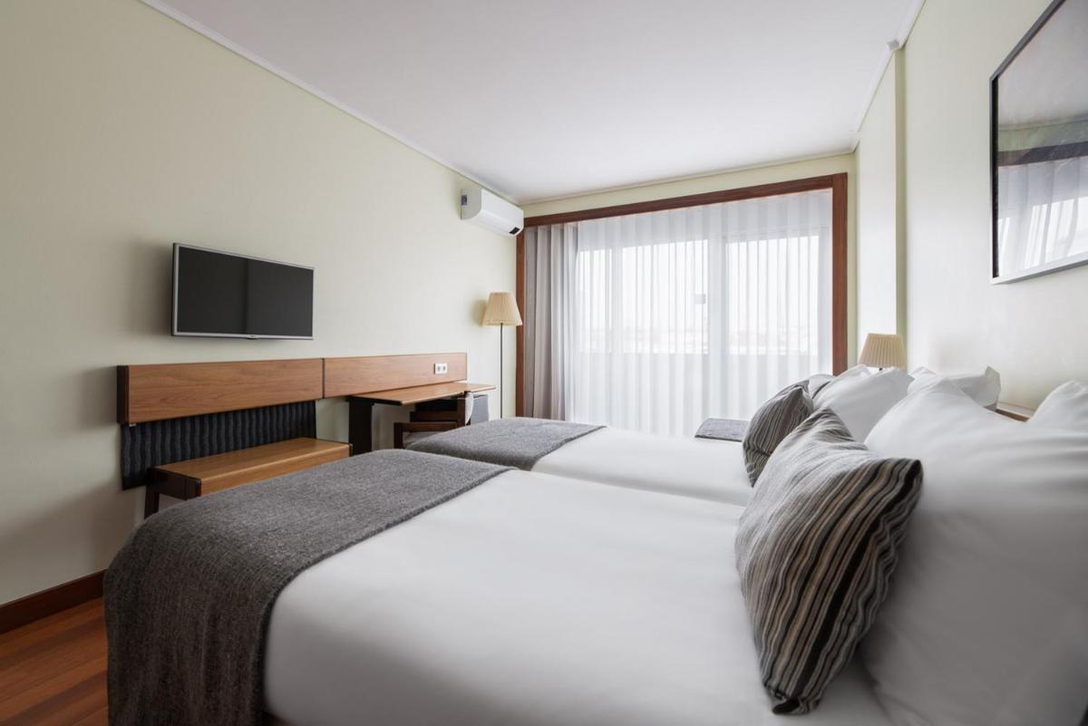 Uma cama ou camas num quarto em Dorma Praia Golfe