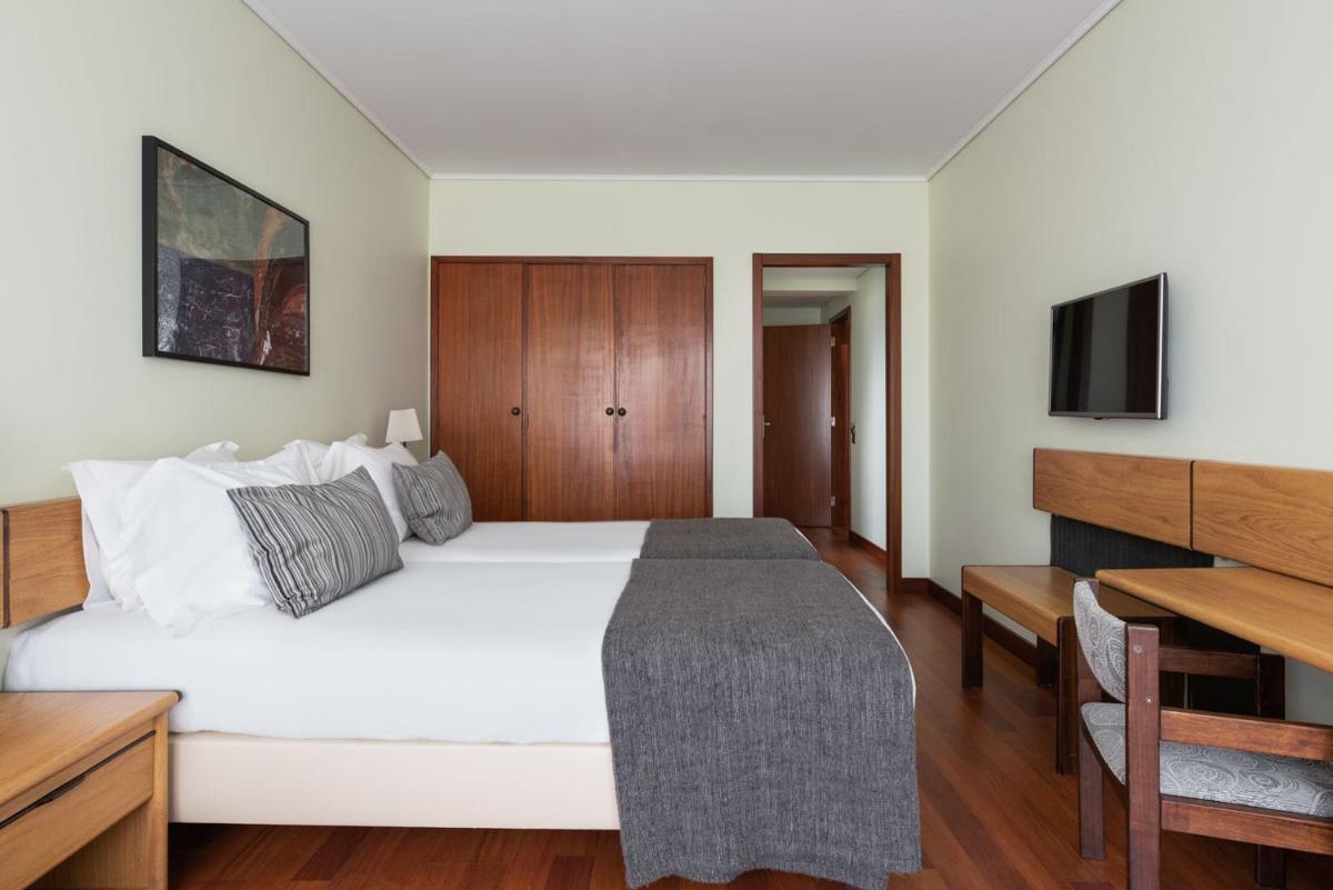 Uma cama ou camas num quarto em Dorma Praia Golfe