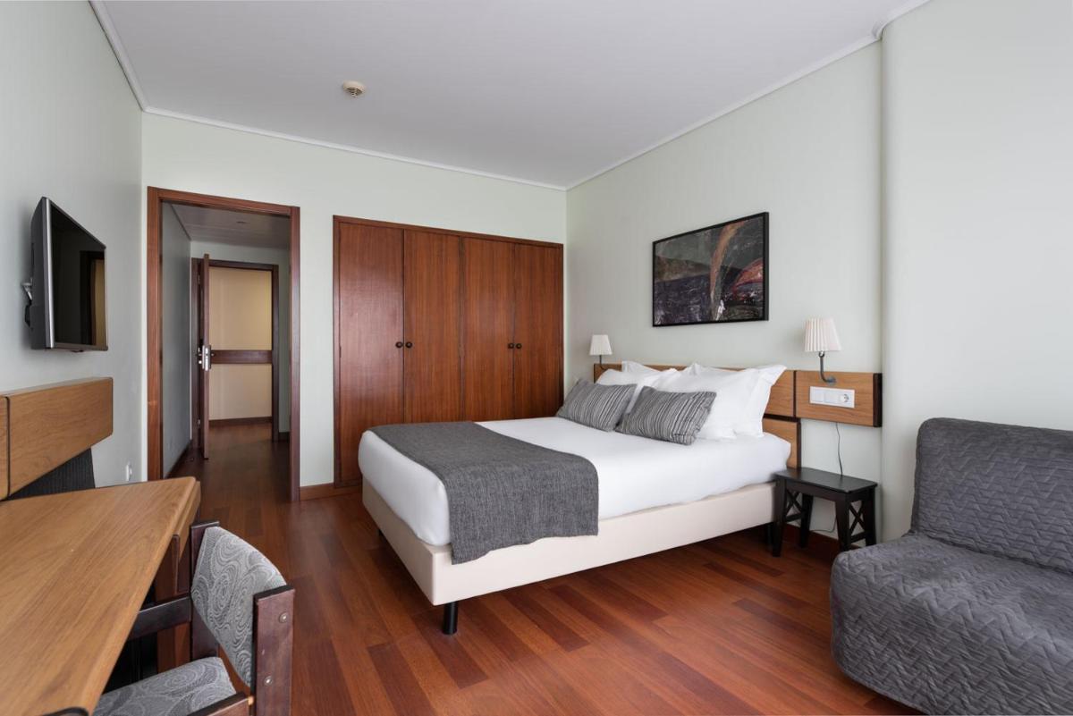 Uma cama ou camas num quarto em Dorma Praia Golfe