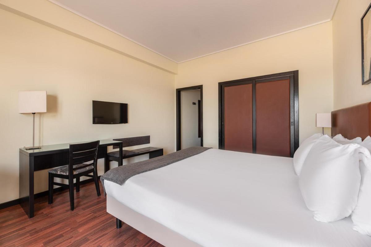 Uma cama ou camas num quarto em Dorma Praia Golfe
