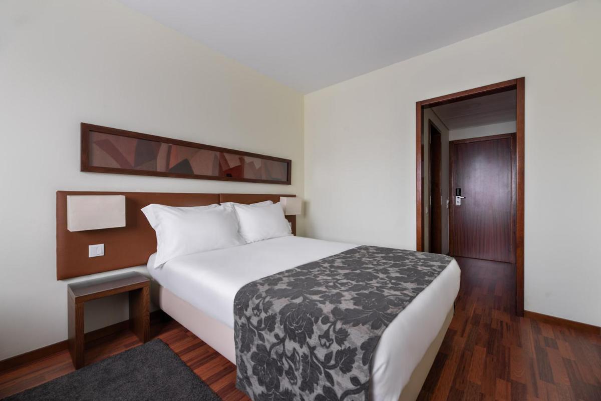 Uma cama ou camas num quarto em Dorma Praia Golfe