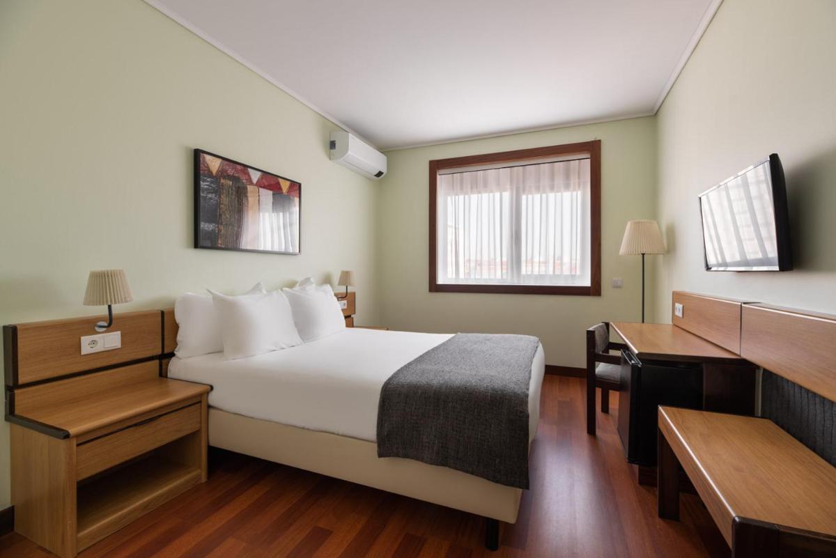 Uma cama ou camas num quarto em Dorma Praia Golfe