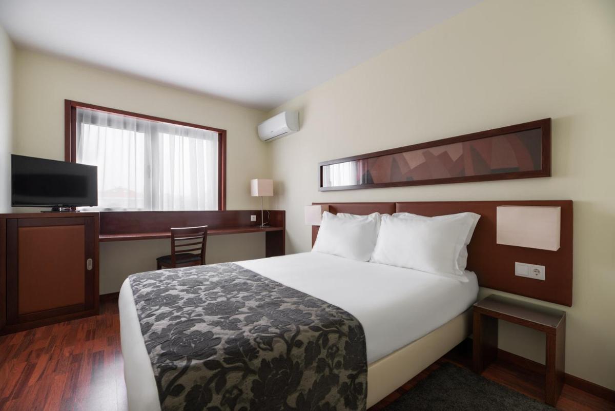 Uma cama ou camas num quarto em Dorma Praia Golfe