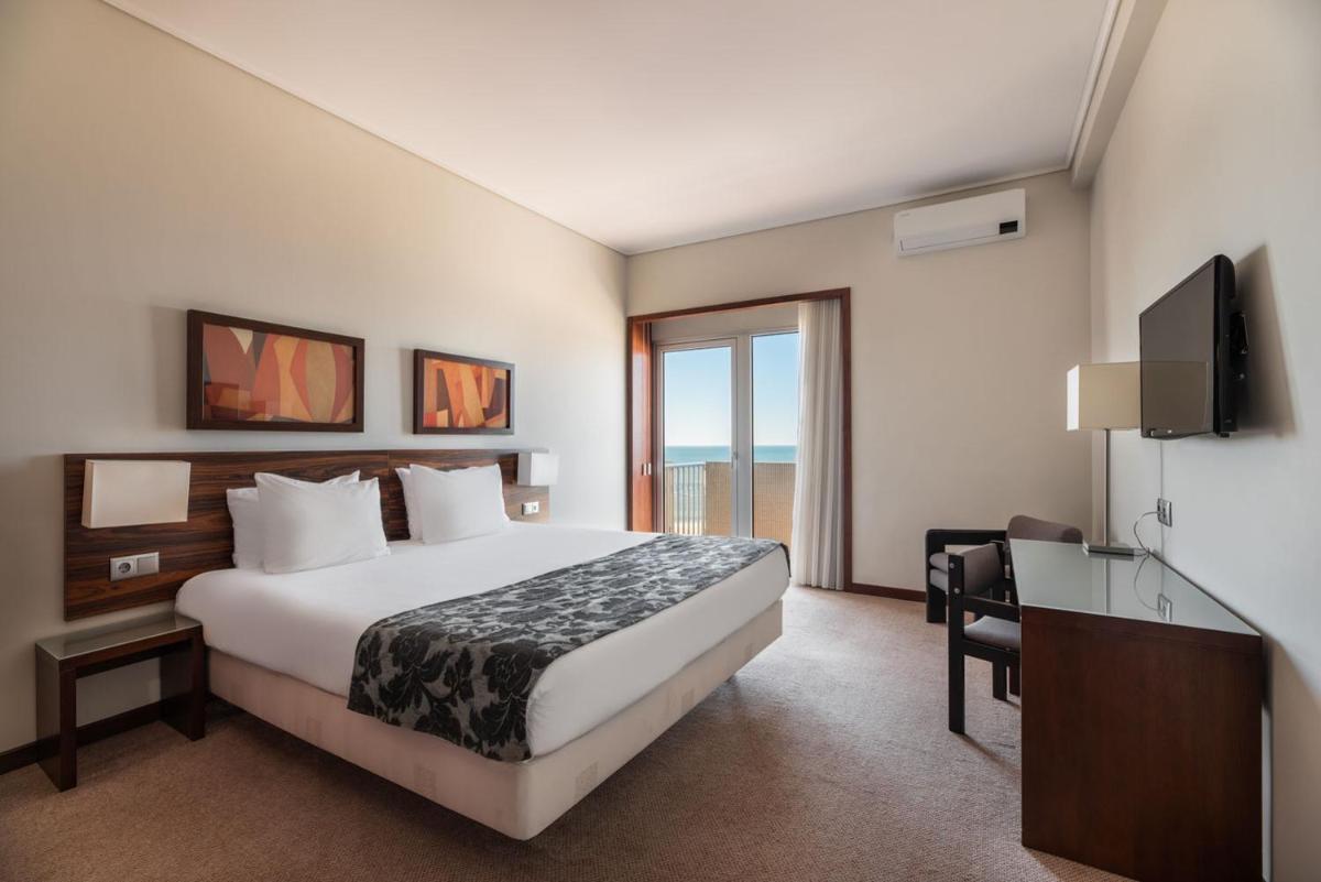 Uma cama ou camas num quarto em Dorma Praia Golfe