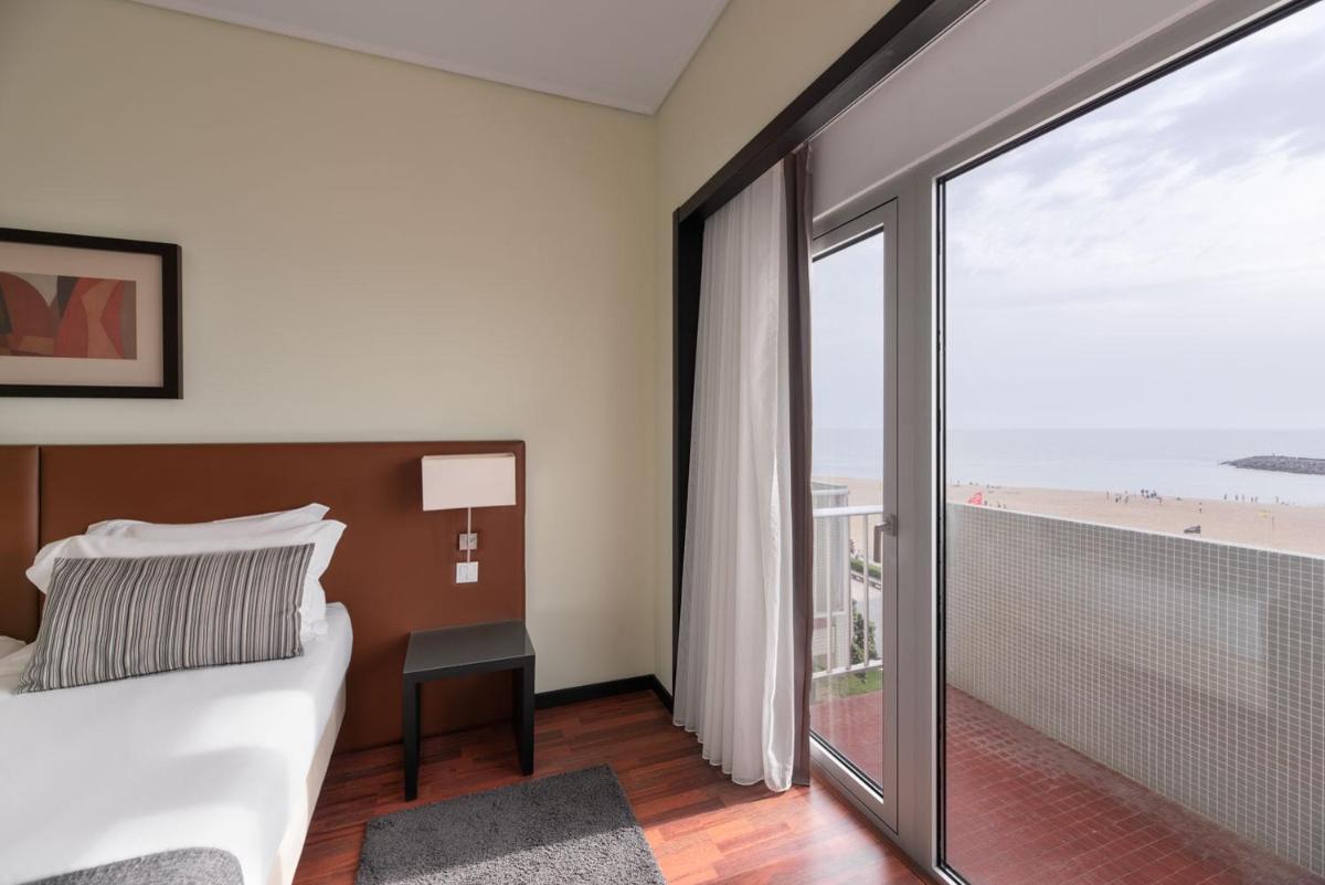 Uma cama ou camas num quarto em Dorma Praia Golfe