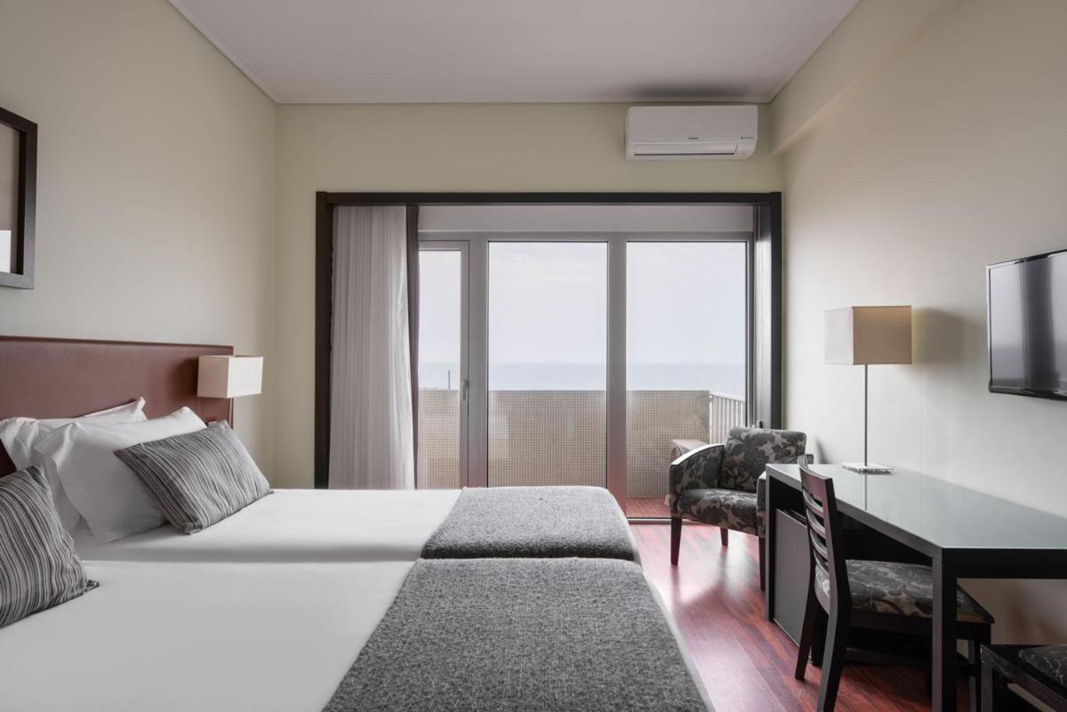 Uma cama ou camas num quarto em Dorma Praia Golfe