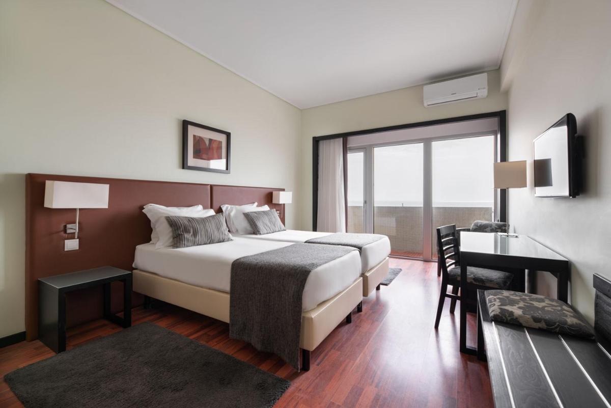 Uma cama ou camas num quarto em Dorma Praia Golfe