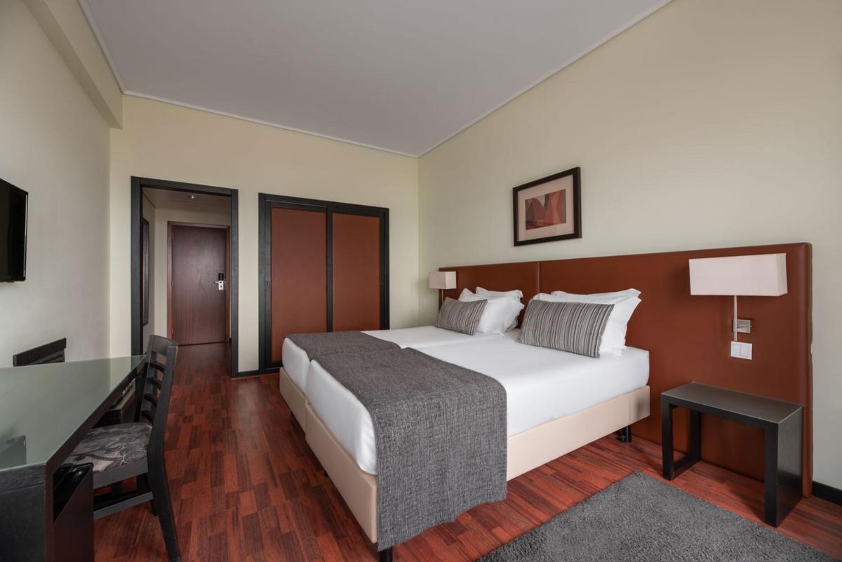 Uma cama ou camas num quarto em Dorma Praia Golfe