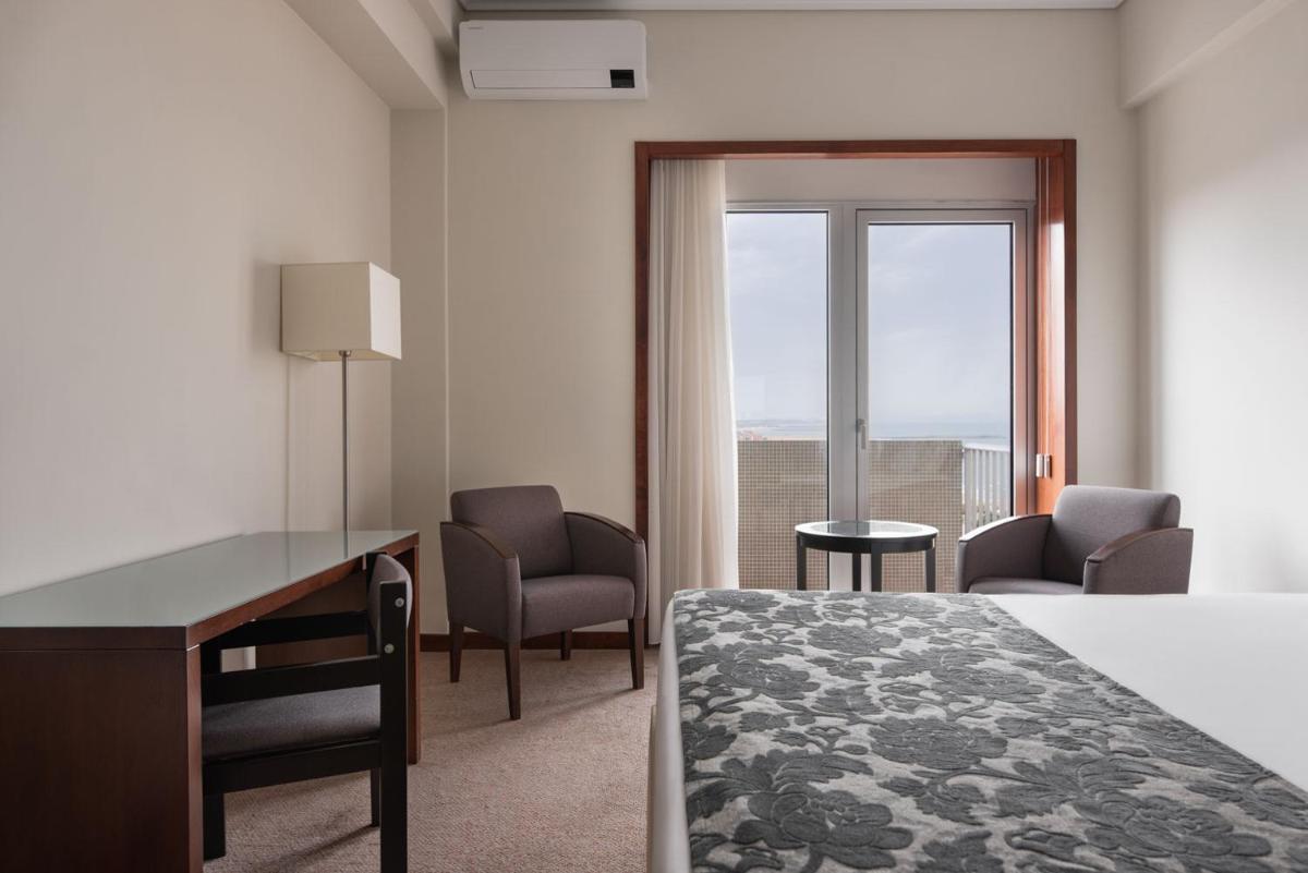 Uma cama ou camas num quarto em Dorma Praia Golfe