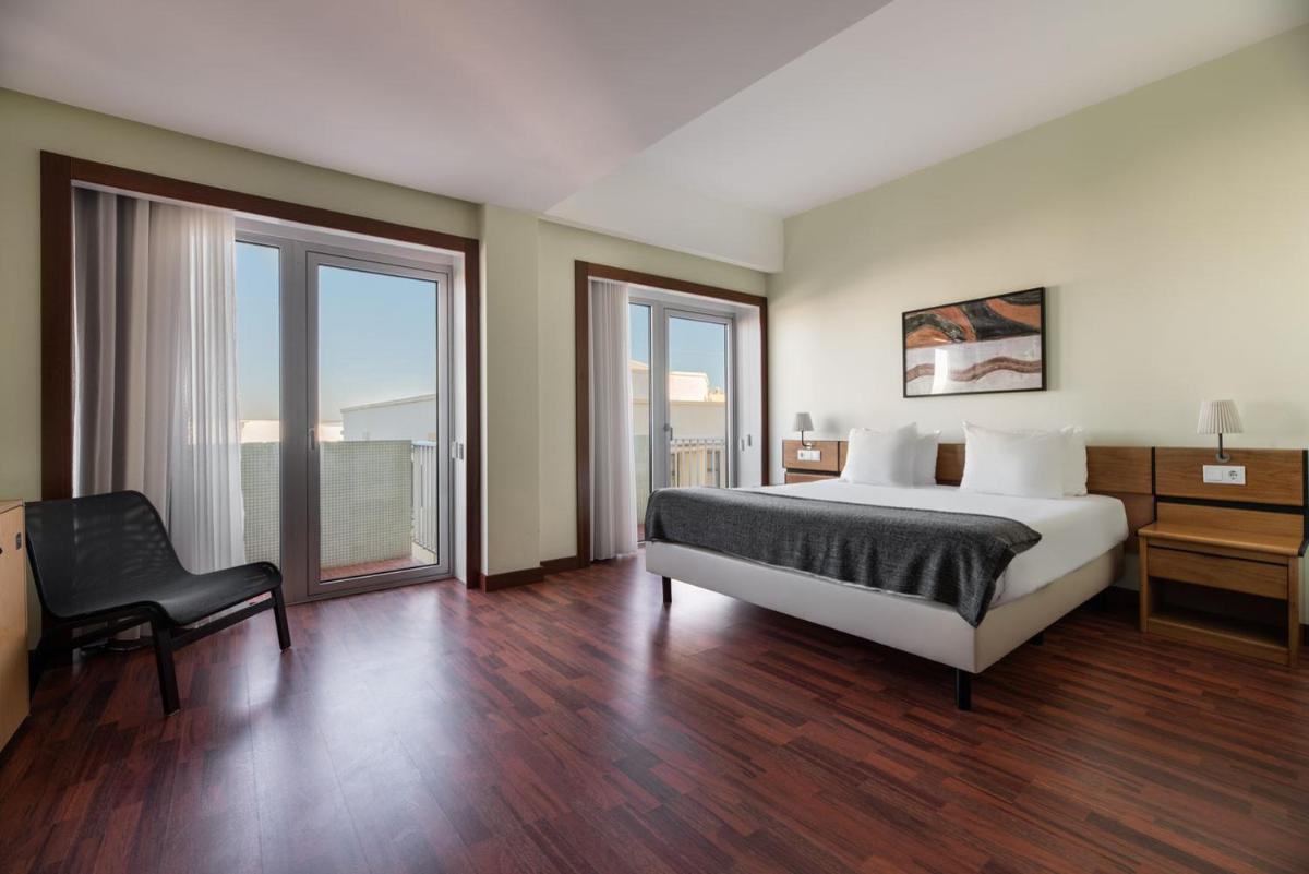 Uma cama ou camas num quarto em Dorma Praia Golfe