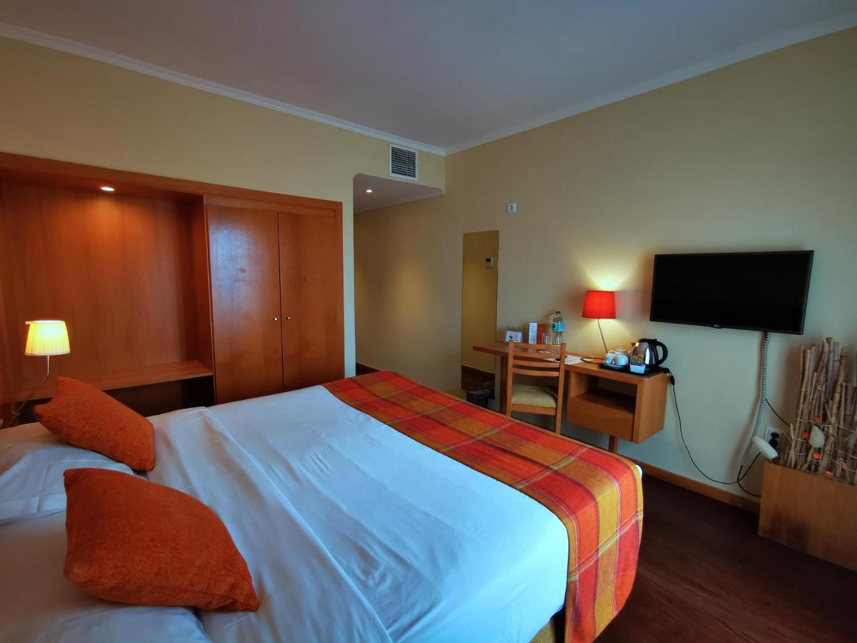 Uma cama ou camas num quarto em Hotel Da Montanha