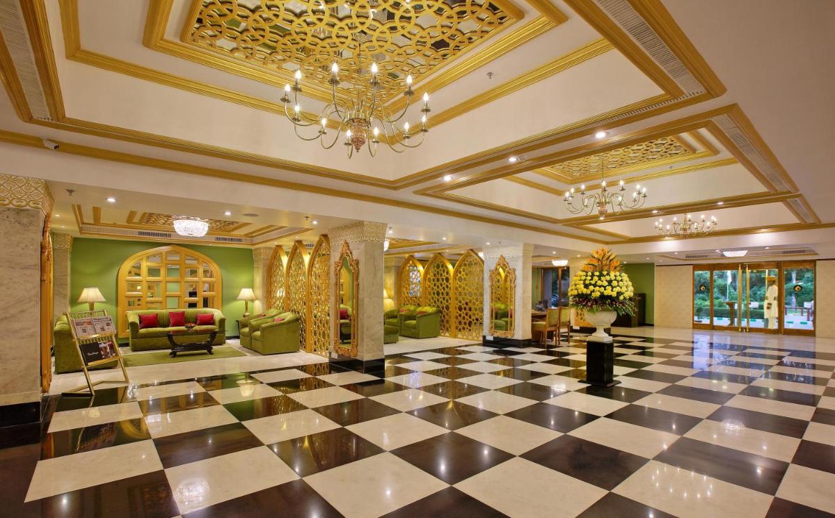 a lobby with a black and white checkered floor at Hotel Clarks Shiraz in Agra