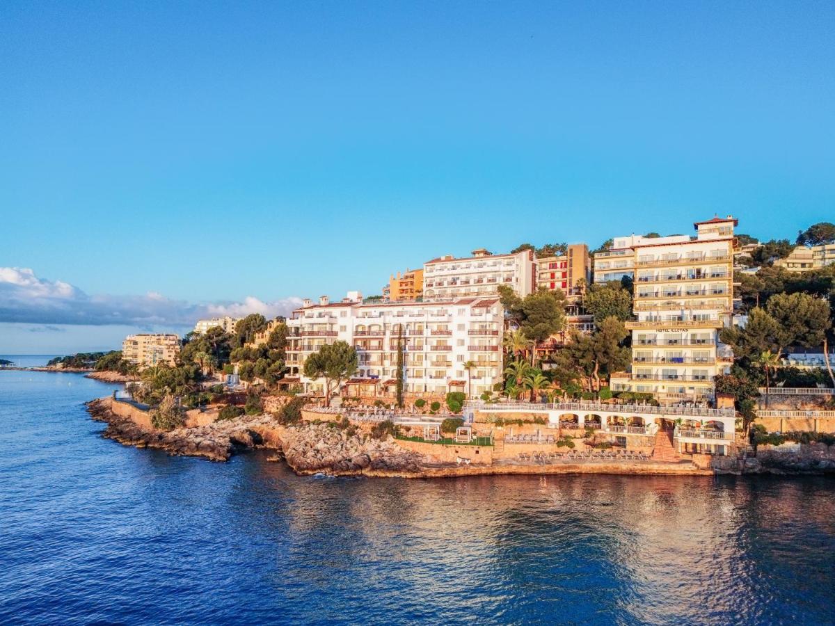 un grupo de edificios en una colina junto al agua en Hotel ROC Illetas & SPA, en Illetas
