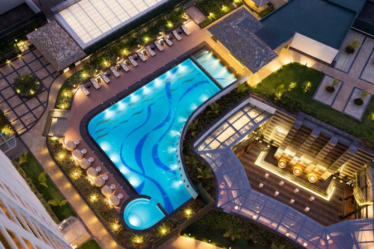 an overhead view of a swimming pool in a building at Bengaluru Marriott Hotel Whitefield in Bengaluru