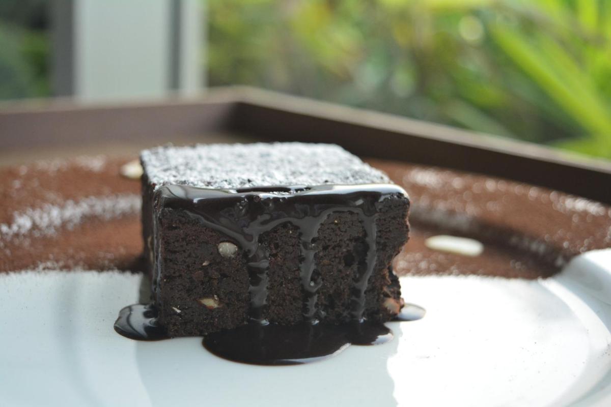a piece of chocolate cake sitting on a table at Holiday Inn New Delhi Aerocity by IHG in New Delhi