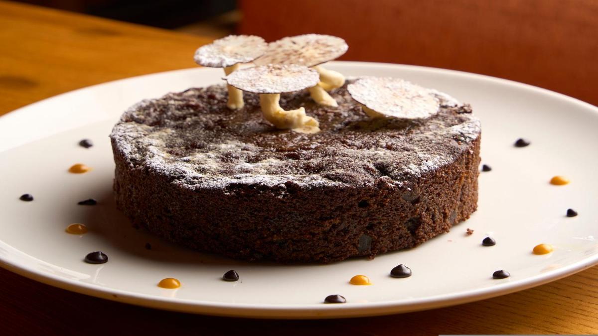 a chocolate cake with mushrooms on top on a plate at Holiday Inn New Delhi Aerocity by IHG in New Delhi