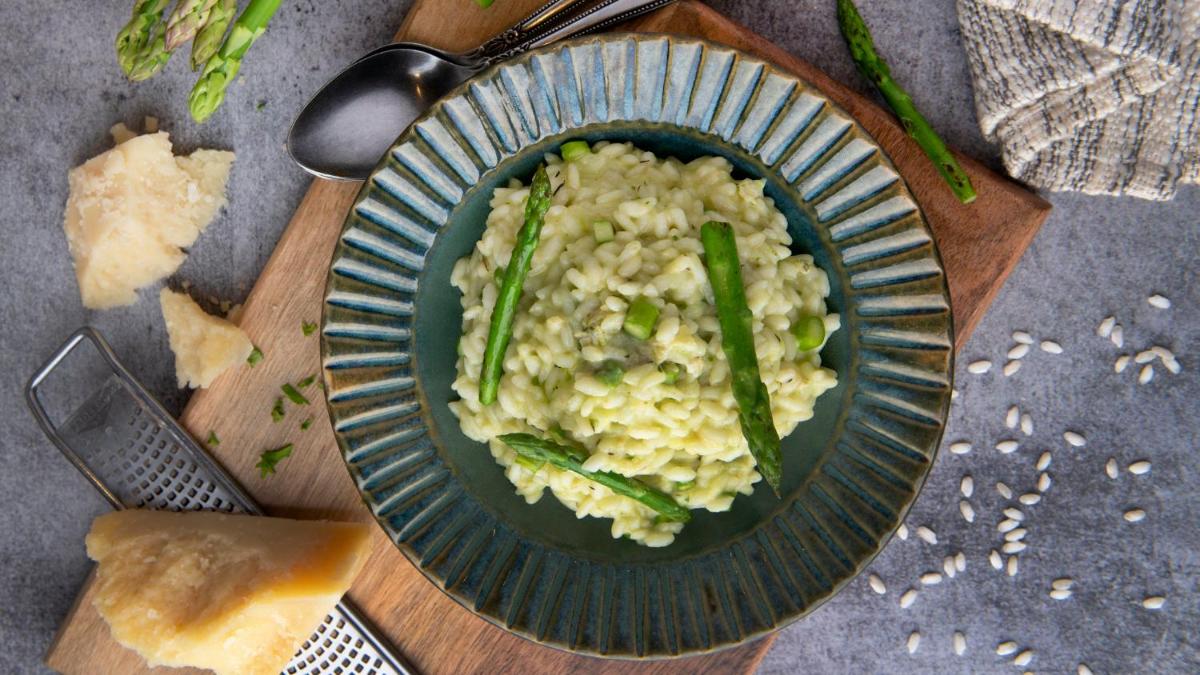 a plate of rice and asparagus on a table at Holiday Inn New Delhi Aerocity by IHG in New Delhi