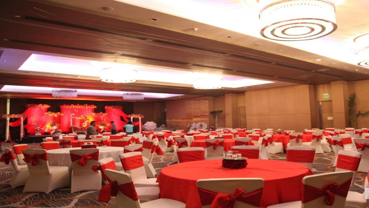 a banquet hall with red and white tables and chairs at Holiday Inn New Delhi Aerocity by IHG in New Delhi