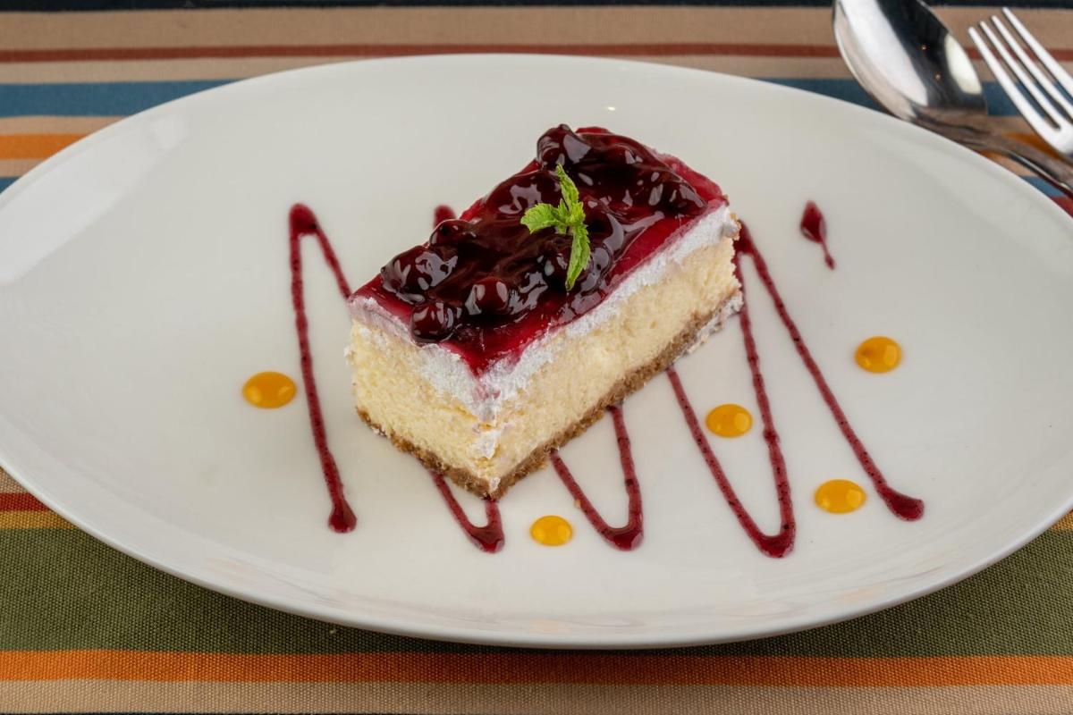 a piece of cake on a plate with chocolate sauce at Holiday Inn New Delhi Aerocity by IHG in New Delhi