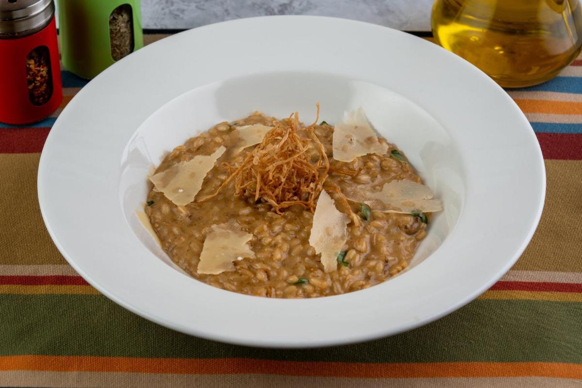 a white bowl of food on a table at Holiday Inn New Delhi Aerocity by IHG in New Delhi