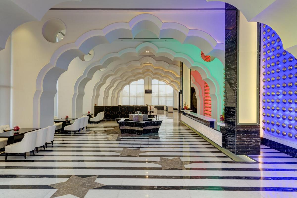 a lobby with a colorful ceiling and stars on the floor at Saura Hotel, Agra - A Club Mahindra Associate in Agra