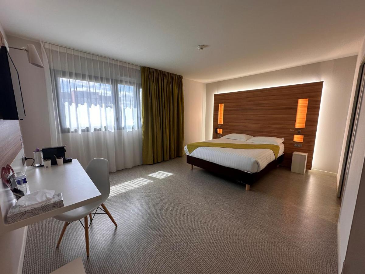 Un ou plusieurs lits dans un hébergement de l'établissement Brit Hotel & Spa Saint Brieuc Plérin