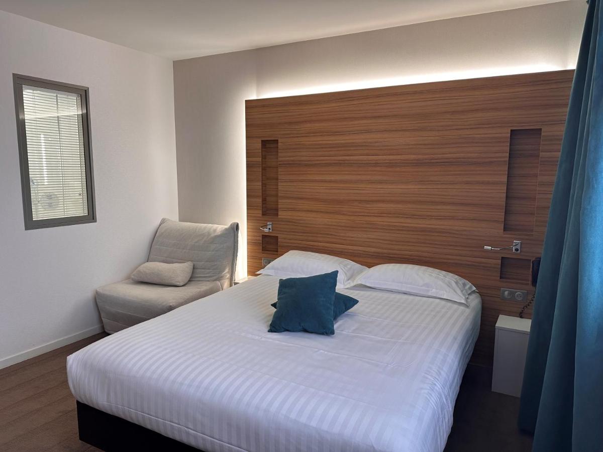 Un ou plusieurs lits dans un hébergement de l'établissement Brit Hotel & Spa Saint Brieuc Plérin