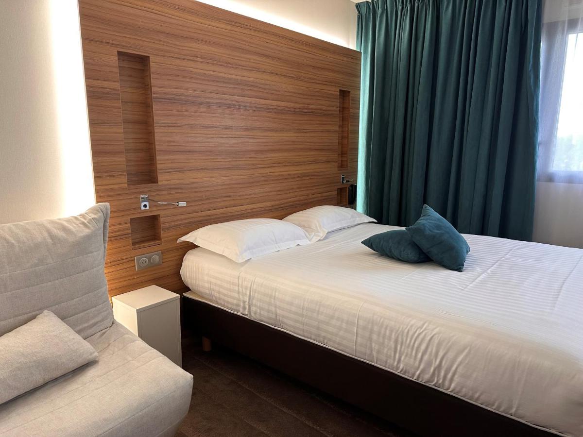 Un ou plusieurs lits dans un hébergement de l'établissement Brit Hotel & Spa Saint Brieuc Plérin