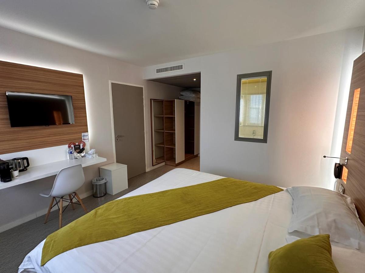 Un ou plusieurs lits dans un hébergement de l'établissement Brit Hotel & Spa Saint Brieuc Plérin