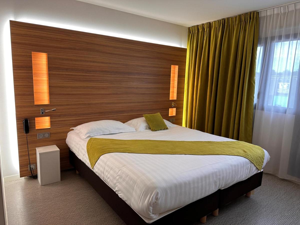 Un ou plusieurs lits dans un hébergement de l'établissement Brit Hotel & Spa Saint Brieuc Plérin