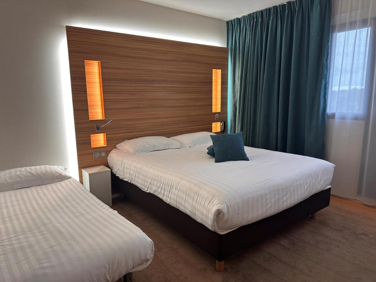 Un ou plusieurs lits dans un hébergement de l'établissement Brit Hotel & Spa Saint Brieuc Plérin