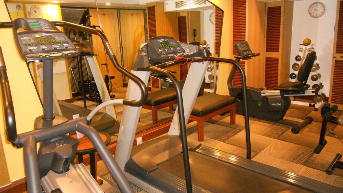 a room with a gym with a treadmill and ellipticals at Hotel Marine Plaza in Mumbai