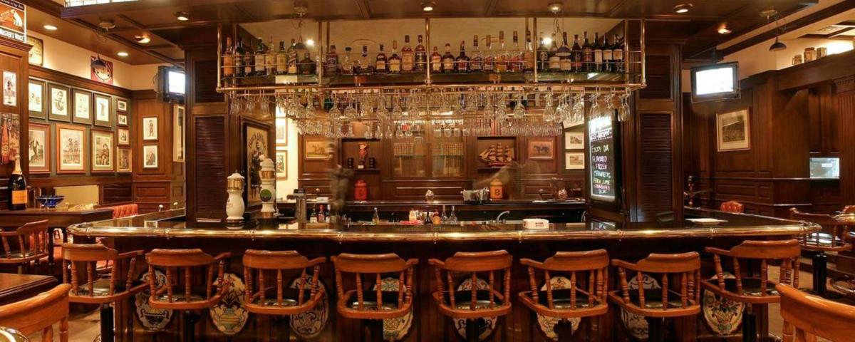 a bar with a bunch of bar stools at Hotel Marine Plaza in Mumbai