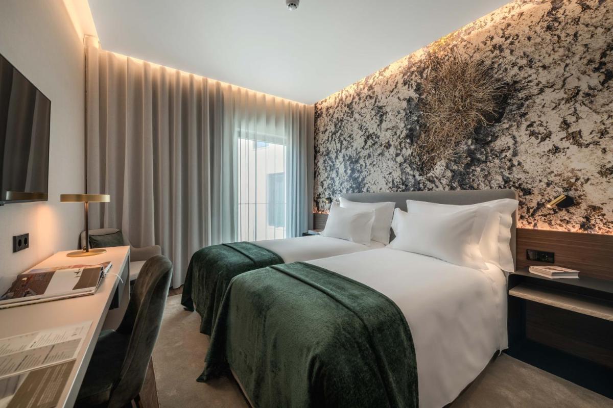 Uma cama ou camas num quarto em Dolinas Climbing Hotel