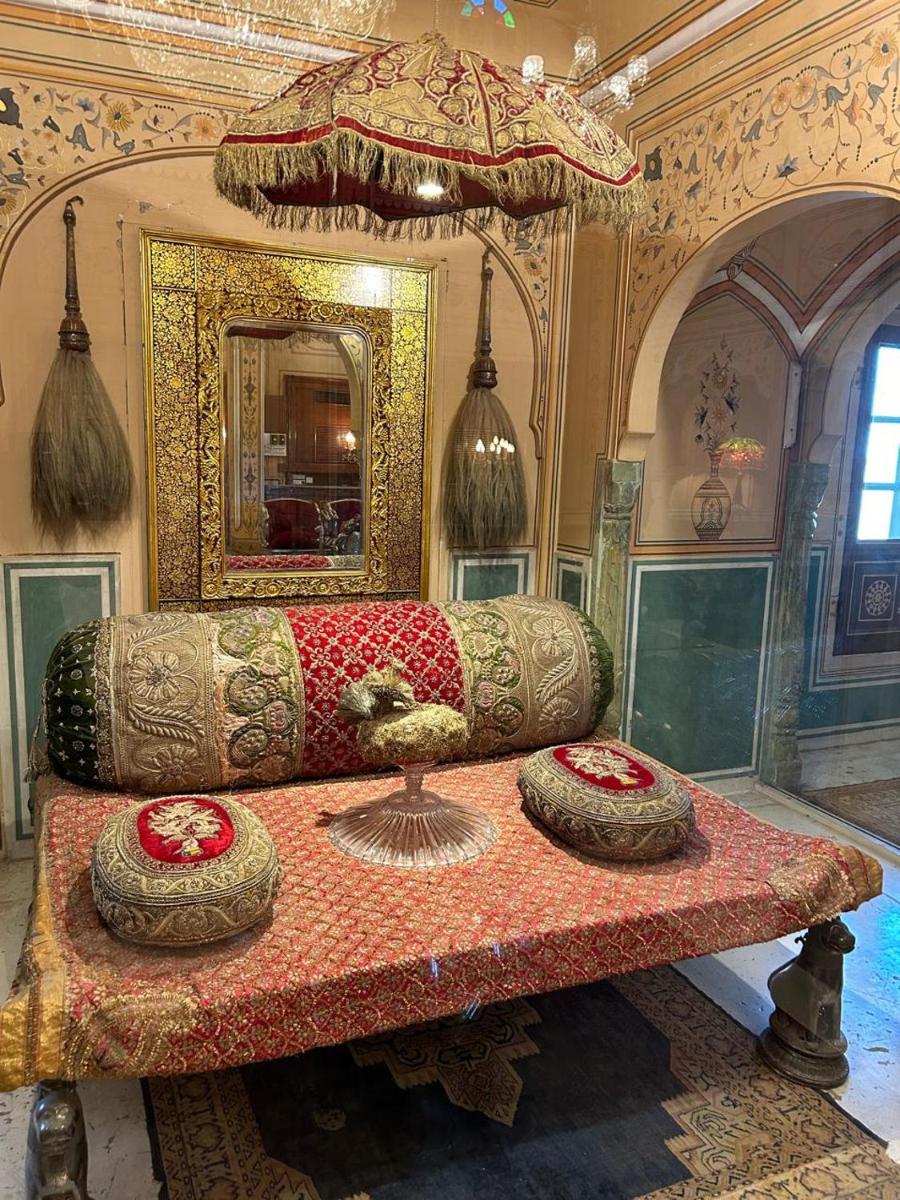 a living room with a couch and a table at The Raj Palace (Small Luxury Hotels of the World) in Jaipur