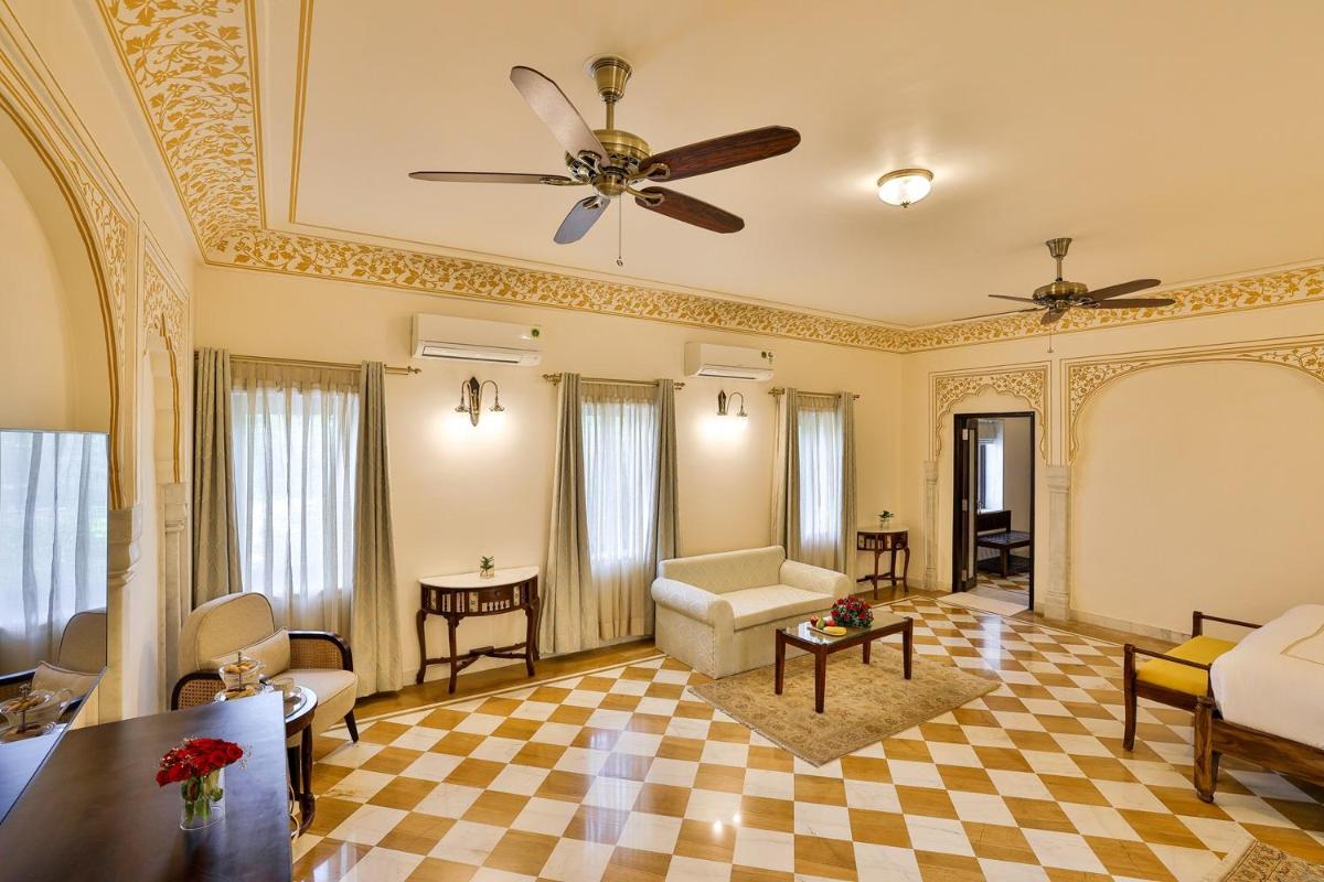 a living room with a ceiling fan and a checkered floor at Royal Heritage Haveli - By Leisure Hotels in Jaipur
