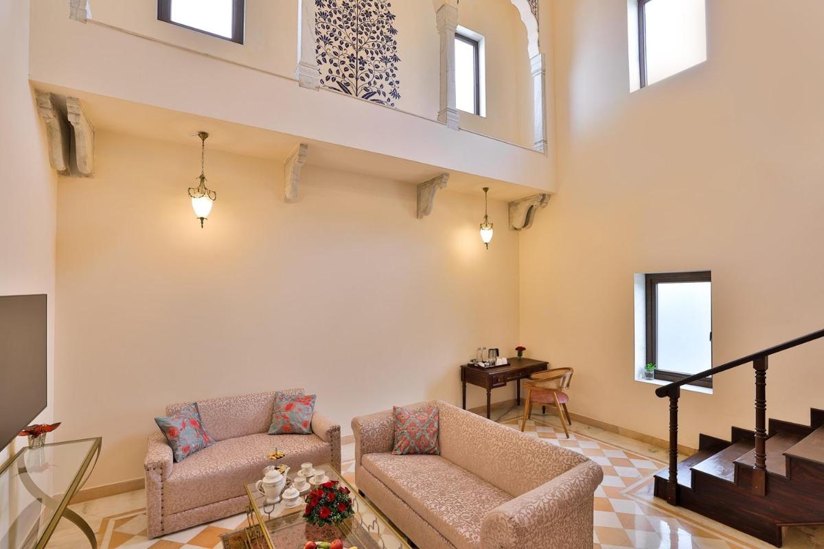 a living room with two chairs and a table at Royal Heritage Haveli - By Leisure Hotels in Jaipur
