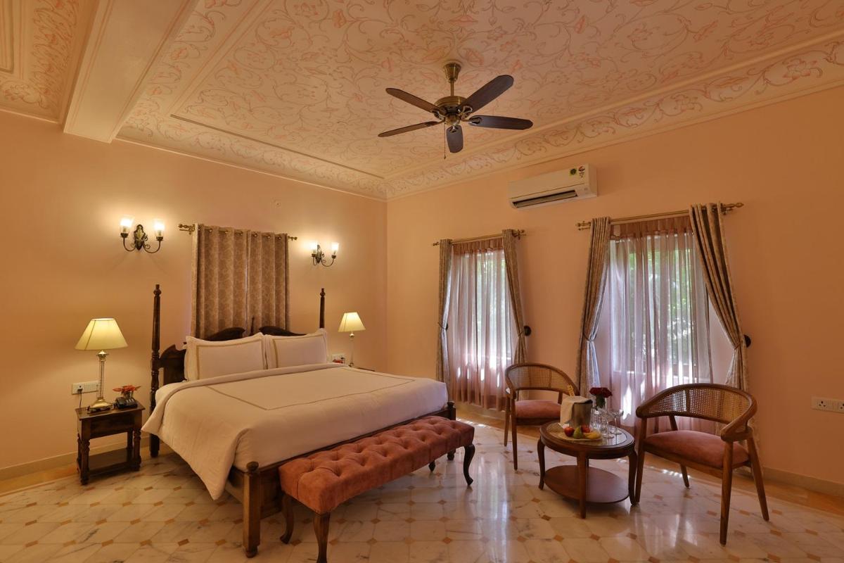 a bedroom with a bed and a ceiling fan at Royal Heritage Haveli - By Leisure Hotels in Jaipur