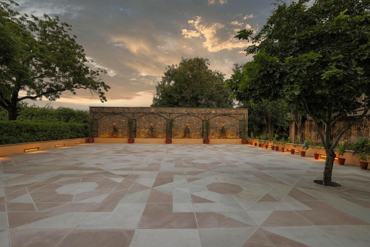 a large patio with a tree and a building at Royal Heritage Haveli - By Leisure Hotels in Jaipur