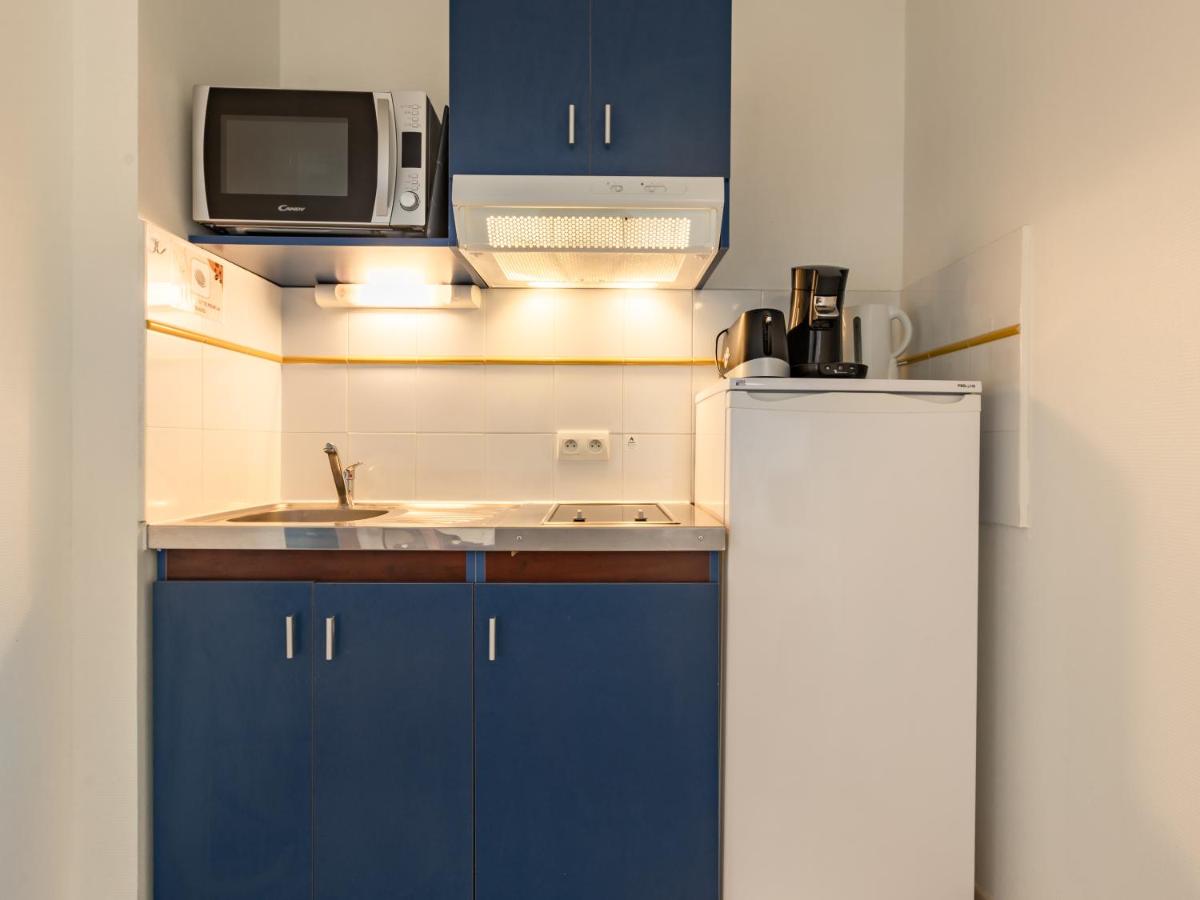 Cuisine ou kitchenette dans l'établissement Vacancéole - Appart'Vacances Pyrénées 2000