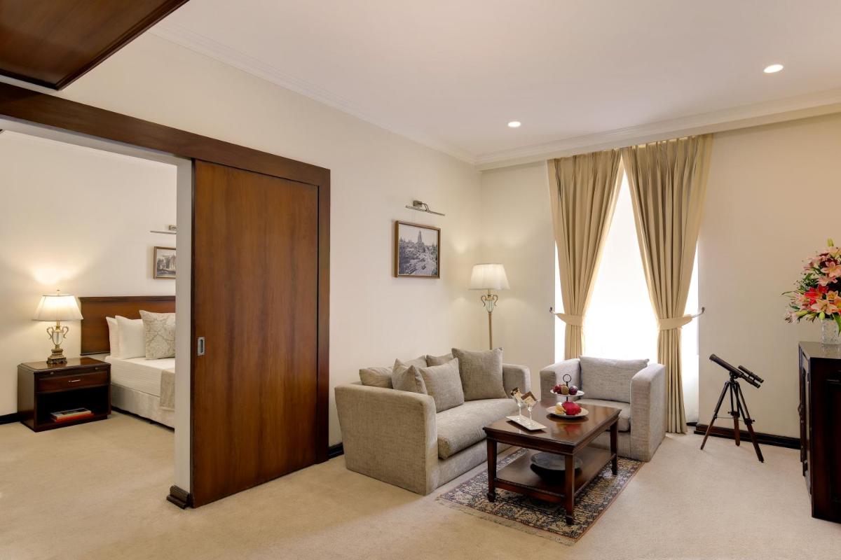 a living room with a couch and a bed at Ambassador, New Delhi - IHCL SeleQtions in New Delhi a living room with a couch and a bed at Ambassador, New Delhi - IHCL SeleQtions in New Delhi