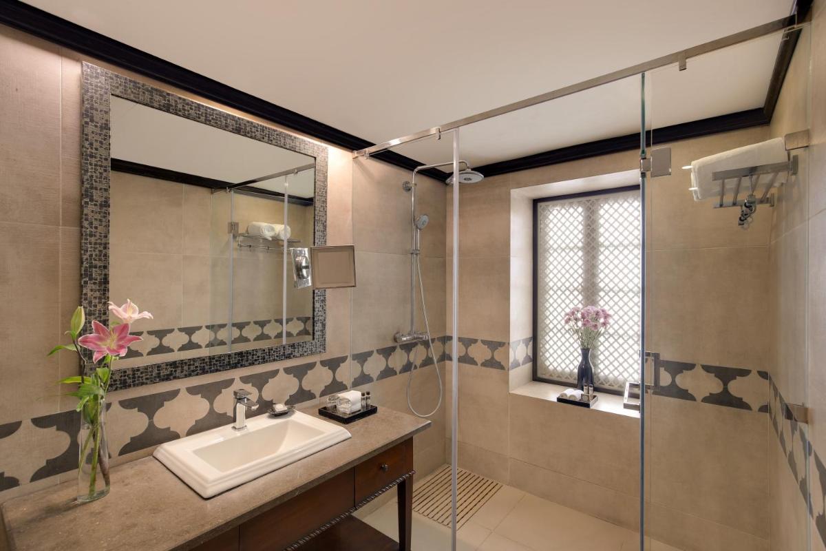 a bathroom with a sink and a shower at Ambassador, New Delhi - IHCL SeleQtions in New Delhi a bathroom with a sink and a shower at Ambassador, New Delhi - IHCL SeleQtions in New Delhi