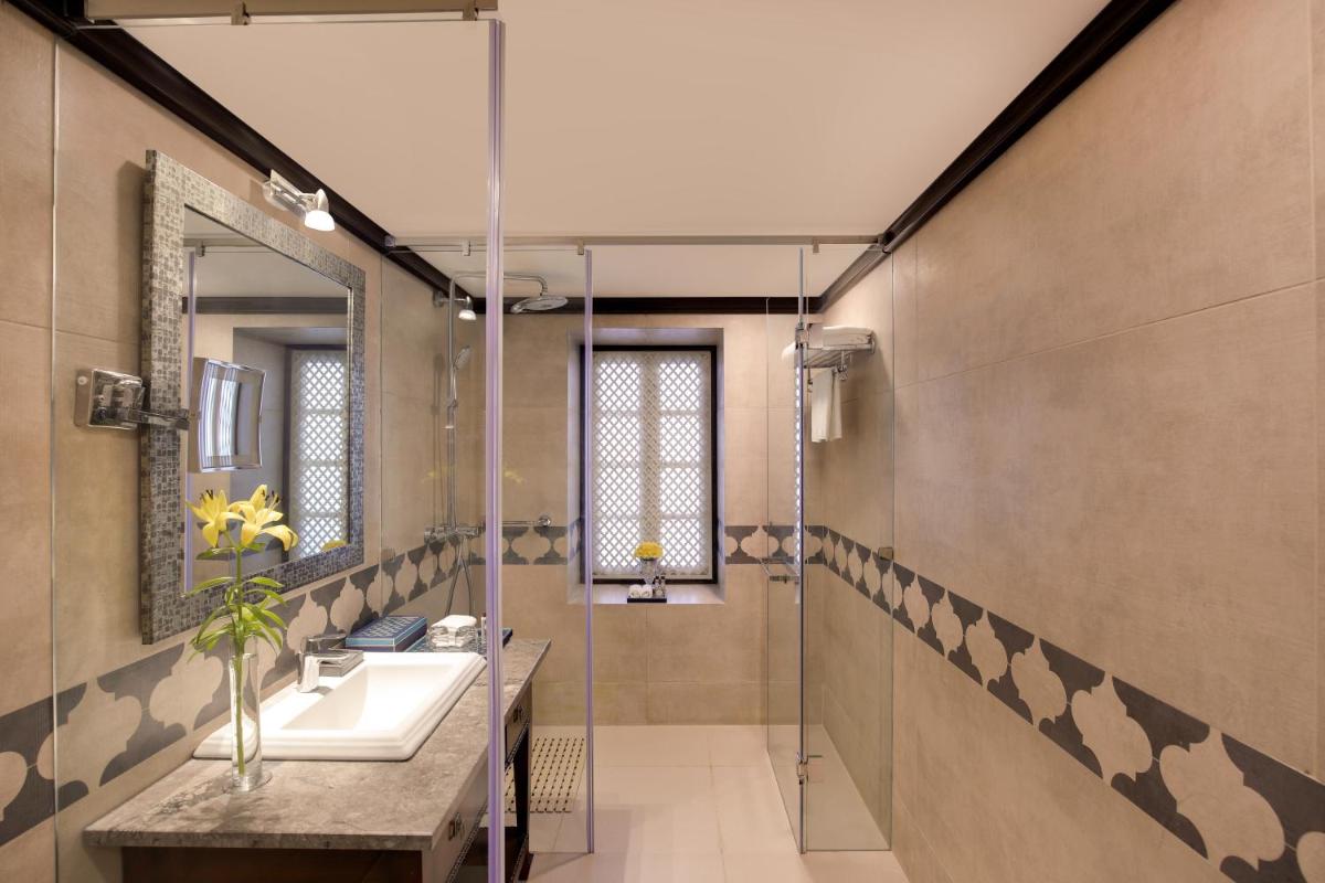 a bathroom with a sink and a shower at Ambassador, New Delhi - IHCL SeleQtions in New Delhi a bathroom with a sink and a shower at Ambassador, New Delhi - IHCL SeleQtions in New Delhi