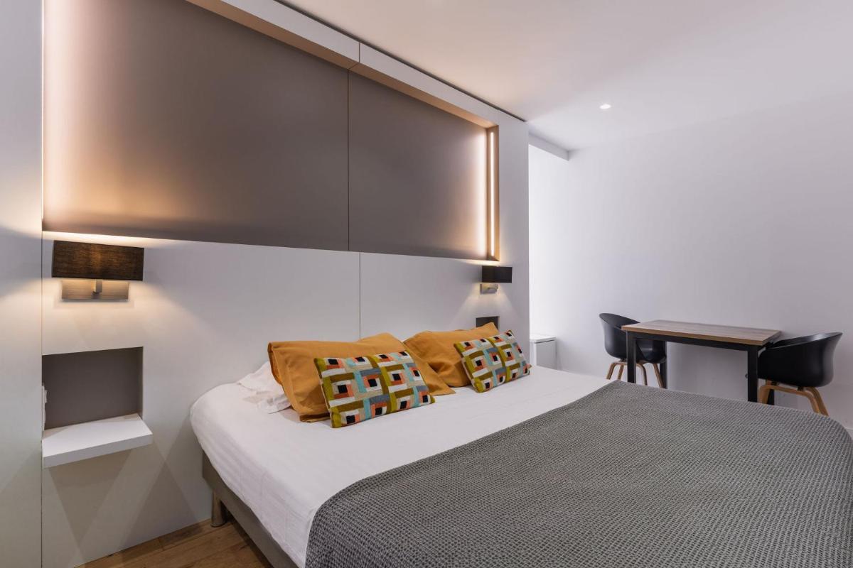 Un ou plusieurs lits dans un hébergement de l'établissement Le Cornouaille Hotel & Spa