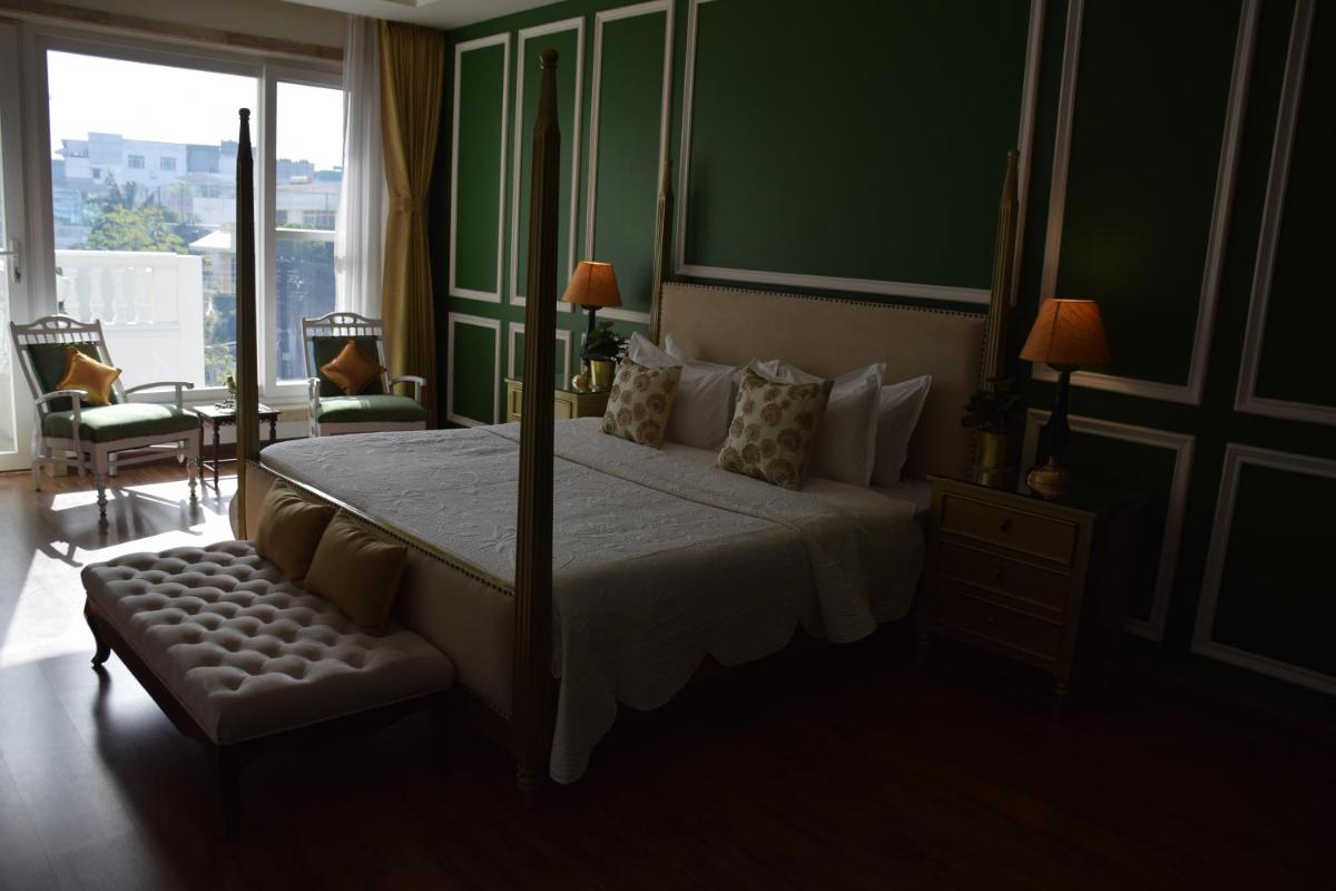 a bedroom with a large bed and a large window at Dileep Kothi - A Royal Boutique Luxury Suites in Jaipur in Jaipur