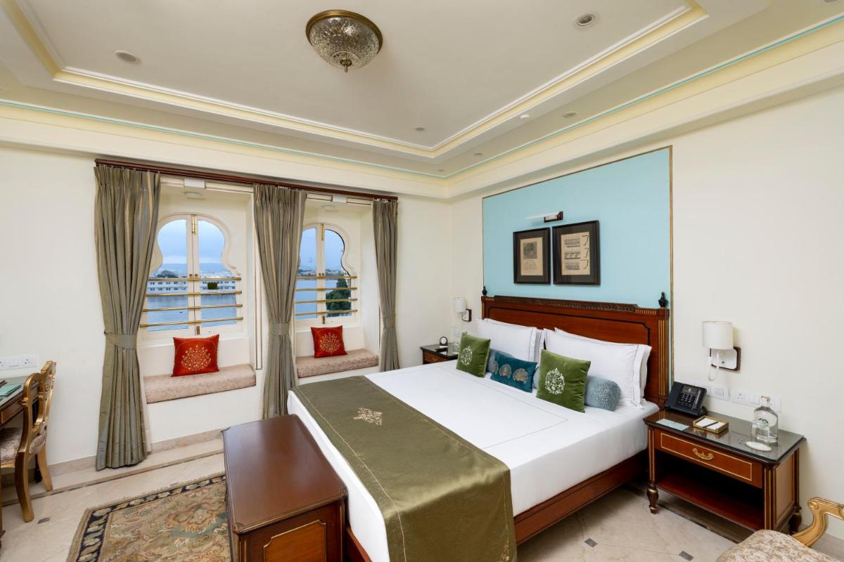 a bedroom with a large bed and a window at Taj Fateh Prakash Palace Udaipur in Udaipur