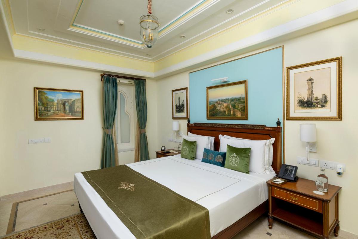 a bedroom with a large white bed in a room at Taj Fateh Prakash Palace Udaipur in Udaipur