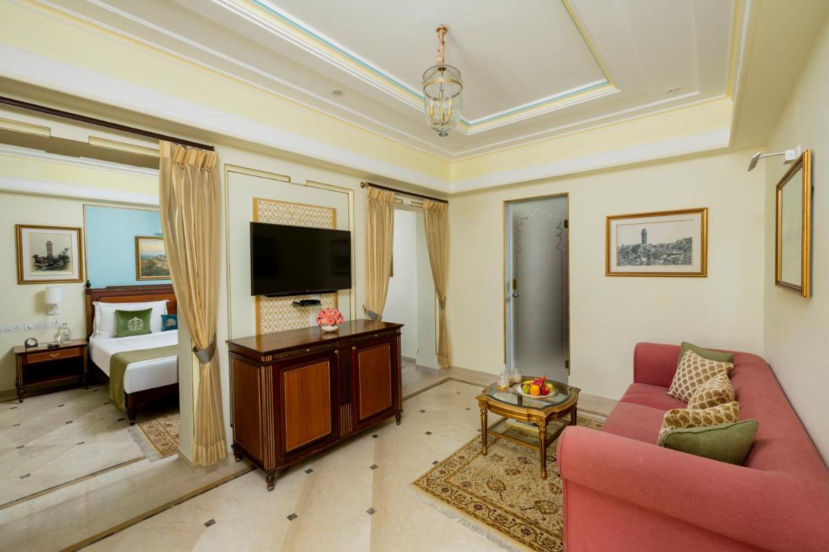 a living room with a couch and a tv at Taj Fateh Prakash Palace Udaipur in Udaipur
