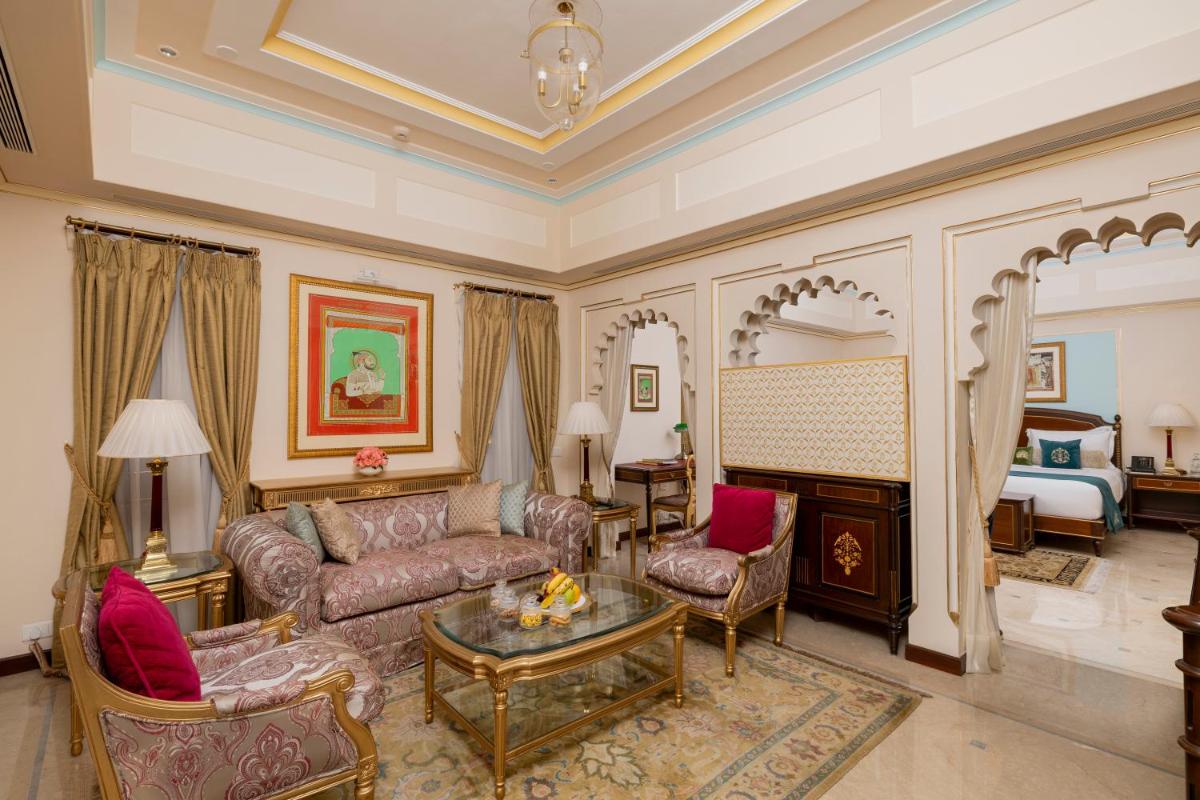 a living room with a couch and a bed at Taj Fateh Prakash Palace Udaipur in Udaipur