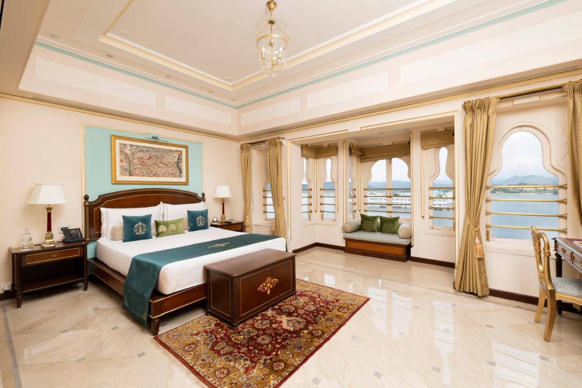 a bedroom with a bed and a large window at Taj Fateh Prakash Palace Udaipur in Udaipur